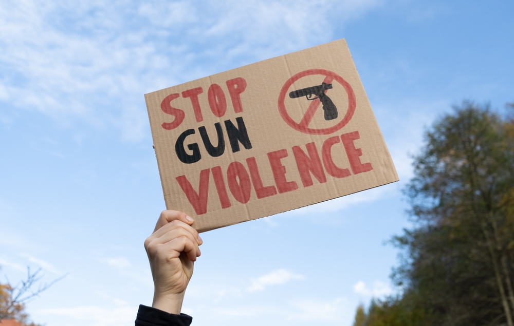 Person holding "Stop Gun Violence" Sign