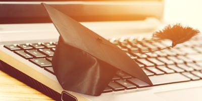 image of a graduation cap on a laptop